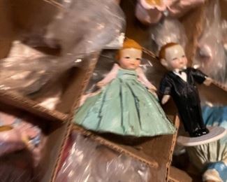 63. Dolls, dolls and some 1940s paper mache little individual guys. Also a Barbie Kaboodle and barbie card game and small wood blue dining set for a doll $50