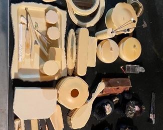 64. Some bakelite, and something else.  Makeup set with mirrors and more including perfum bottles $75