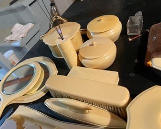 64. Some bakelite, and something else.  Makeup set with mirrors and more including perfum bottles $75