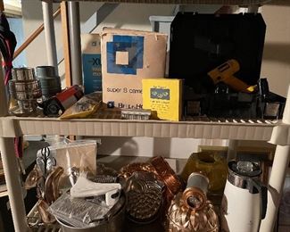 69. Two Plastic shelves with Super 8 Camera, drill, and some cookware $35