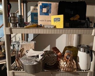 69. Two Plastic shelves with Super 8 Camera, drill, and some cookware $35