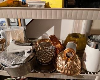 69. Two Plastic shelves with Super 8 Camera, drill, and some cookware $35