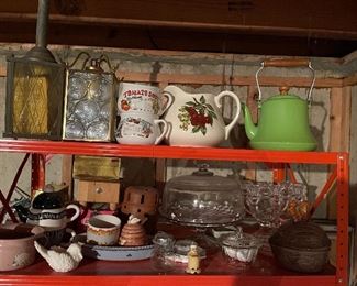 75. Orange metal shelf wtih contents including sugar and creamers, old glassware, tea kettle, two light fixtures and more (Fan in box on left not included) $50