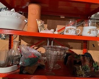 75. Orange metal shelf wtih contents including sugar and creamers, old glassware, tea kettle, two light fixtures and more (Fan in box on left not included) $50