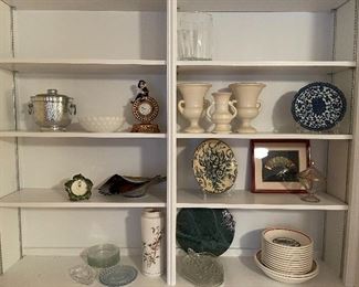 92. 8 shelves of items, including plates, clocks, and more $40