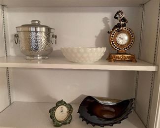 92. 8 shelves of items, including plates, clocks, and more $40