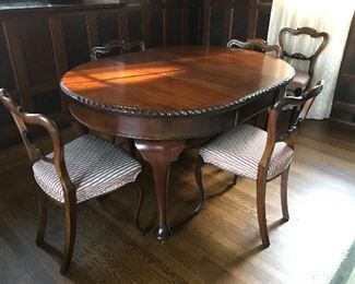 Antique Flame Mahogany Table with Crank Extension (42" round, 30" H - Two 15" leaves. Some condition issues, as shown in additional photos.) including 6 balloon back antique chairs with thistle carved design, recently reupholstered. All likely Scottish. | $1,500