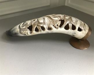 Carved horn with elephant figures, mounted on brass stand, 14.5” W x 5” H. A loss as shown | $125