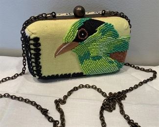 Fun beaded purse by Jasper and Jeena.  Fun bright green beaded purse of an adorable bird. Some missing beads on the side which is pictured. Measures about 6" x 4" 
