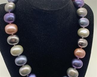 Multi Colored Faux Pearl Necklace in purple, pink and pearly and gray. Magnetic closure and measures 18.5" 