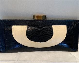 Nice vintage clutch by designer Carlos Falchi in black and white. In good used/vintage condition.  Measures 15" L x 5.2" W