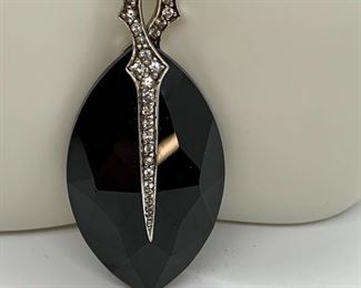 Gorgeous black stone/onyx style large pendant accented with rhinestones. Marked on back 925 and hallmarked "SW". The chain measures 16" and is not sterling. 