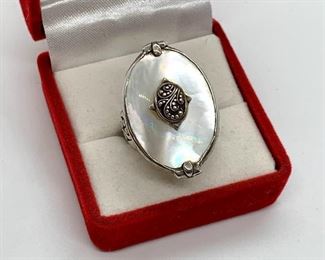 A beautiful ring with mother of pearl design by Lois Hill set in sterling. Size 6.5.