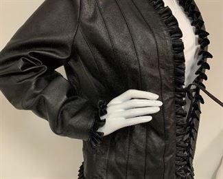 St. John's Leather Jacket with rippled like decorative fridge and tie front. Size 8 and in good used condition. 