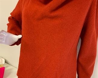 Eileen Fisher Sweater - in a shade of burnt orange; has a buckle leather trip at the top. 100% wool