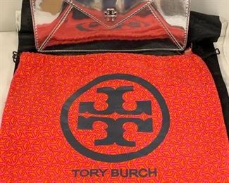 This beautiful clutch has a snap closure and a dust cover. Feels very nice to the touch! The inside has a zipper compartment and the sides have loops for straps which are not included. This has not been authenticated but it is believed to be genuine. Shows light signs of wear. 