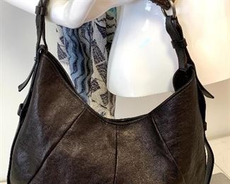 Gorgeous handbag by Yves Saint Laurent. Mombasa Handbag.  Black leather handbag with a bone/antler accented strap. In very good condition with clean interior.  Yves Saint Laurent classic vintage horn handle bag. Rich black leather with tonal topstitching. Adjustable 1" straps which attach to an authentic horn. Brushed silver toned protective metal wrapped at top. Open top with a magnetic tab closure. Inside zipper pocket. Dark brown canvas. Gently loved