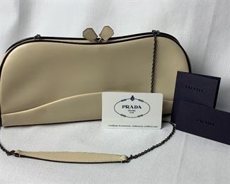 Prada Clutch with Certificate of Authenticity.  Features a thin chain shoulder strap. Measures about 10.5" x 5" 

Information from the certificate of authenticity card: 

ART B11022
Group Name: Rittello Frame
Color: Lavanda + MO