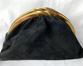Beautiful and classic black suede Donna Karan Clutch. Comes with a little compact mirror that says Donna Karan. Measures approximately 10"  x 8" H. In very good condition with light signs of wear.