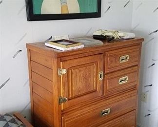 Oak with burnished brass campaign style chest of drawers, posters
