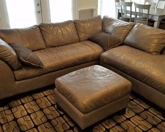 Grey leather sectional very good, no pets, no smoking, black grey, white area rug