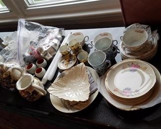 collection of antique tea cups, saucers and plates