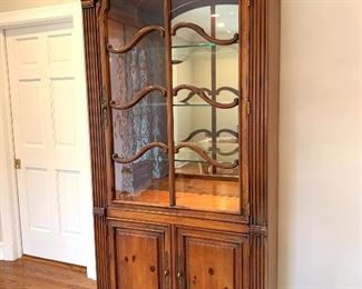 $800 Exquisite Illuminated Curio Cabinet with ornate wood work. Features seeded glass doors to add to the richness of this already stunning piece. Two Doors below allow for additional shelving storage 42”17”x90”