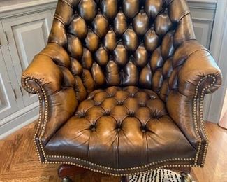 $500-Designer office chair by Hancock and Moore. Features a tufted leather design, rocks and swivels and height is adjustable. 