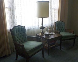 Mid Century matching arm chairs with cane sides and tufted backs.  The walnut end table matches the coffee table.