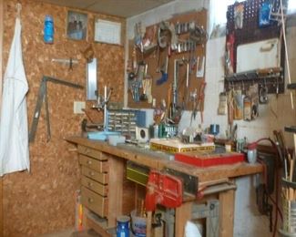 Handmade work bench with vice.  Lots of hand tools and supplies for the handy man.