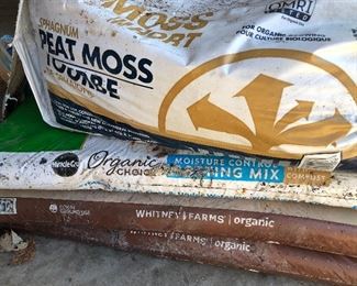 #83) $10 - Four bags of peat moss potting soil.