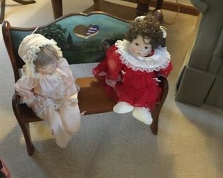 . . . two cute dolls on cute bench
