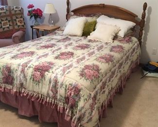 . . . a nice queen-sized bed with beautiful comforter -- notice quilt and side chair to left