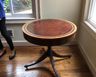 32" leather top table with carved legs and claw feet on wheels