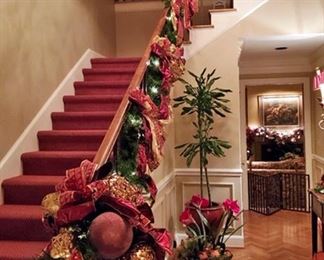 Entry hall banister decorated for Christmas.