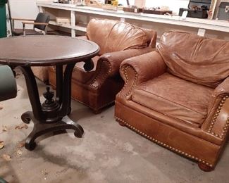 Pair of leather chairs; round wood table