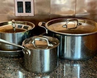 Item 232:  All Clad Pans - Stock Pot, 2 Saucepans and Saute Pan - the saute pan could use a good scrub: $175