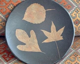 Item 261:  Thick, black matte pottery plate with impressed leaves signed SD '98:  $32