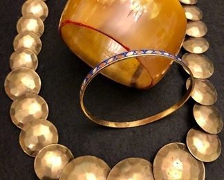Item 109:  (2) Bracelets and one graduated brass disc necklace:  $45