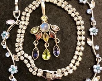 Item 127:  (2) Bracelets and one multi-colored charm:  $45