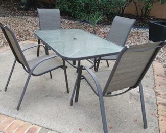 patio table with four chairs 56 in by 36 in by 28 in hod theres an insert for an umbrella