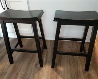 two black wooden 24 inch bar stools