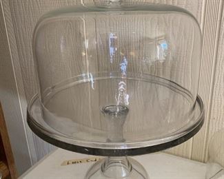 #140	Clear Pedistal Cake Stand w/Lid (lid smaller than should be)  8.5" Tall	 $35.00 
