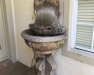 Decorative outside water fountain, approx 6' tall x 32" wide.  Requires electrical outlet nearby.  $250