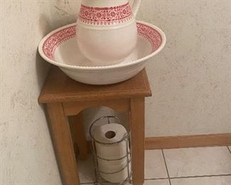 Bathroom decor -- oak table, wash basin with pitcher, toilet paper holder (toilet paper NFS)