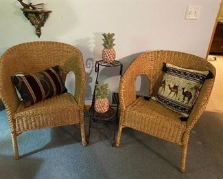 Wicker chairs, accent pillows, plant stand