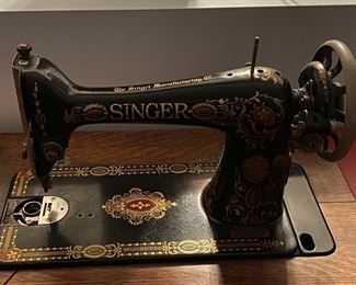 Antique Singer sewing machine in treadle cabinet