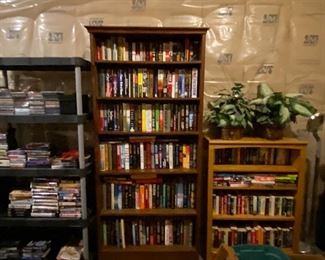 Bookcases, storage shelving, filled with books, DVDs, CDs, VHS tapes
