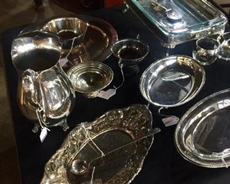 Many silver service pieces