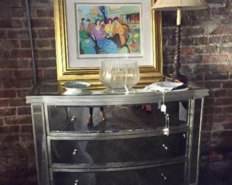 Mirrored chest with bright watercolour over it